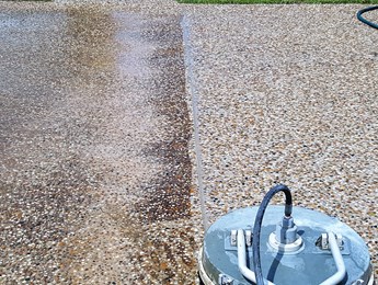 Pressure cleaning of a concrete driveway - one of our concrete cleaning services