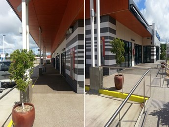 Pressure cleaning of a commercial building and pavement cleaning